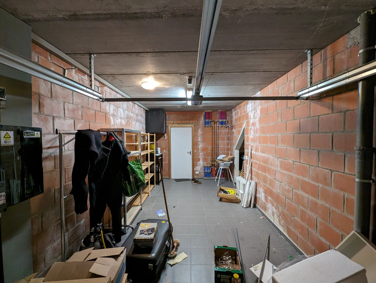 Interior of a garage with shelves and a door