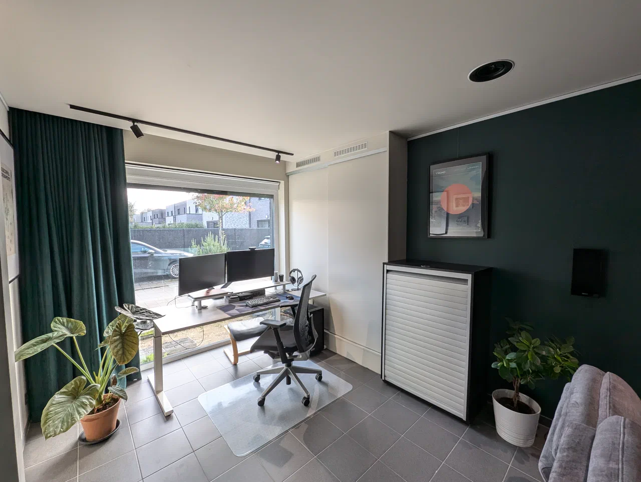 A desk with dual monitors in front of a window