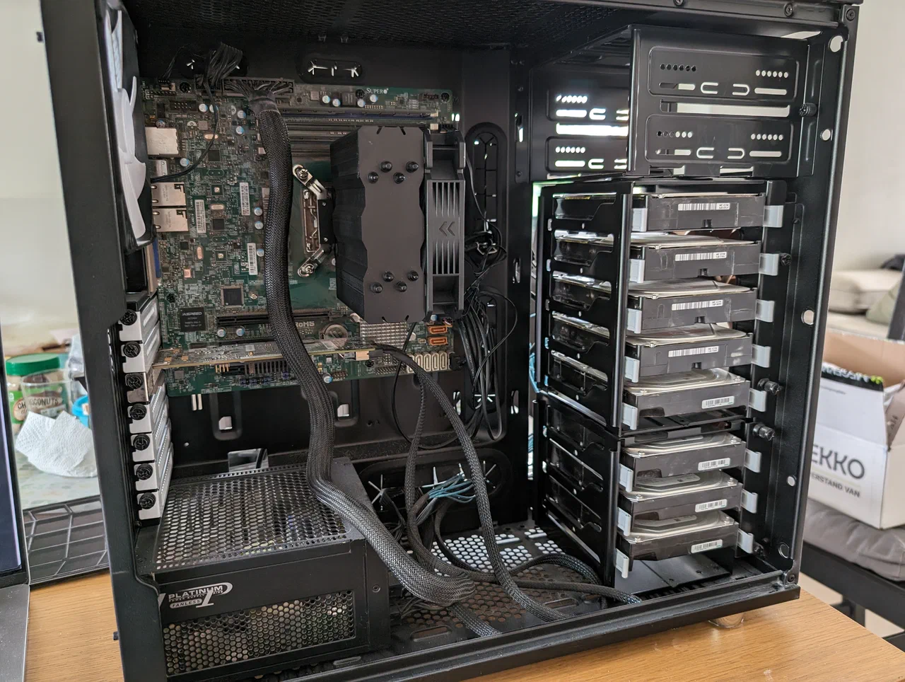 An open computer case with 8 drives installed